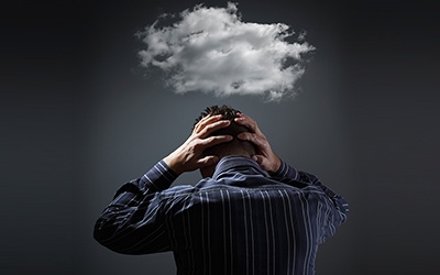 cloud of depression over suffering man